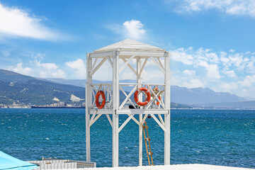 Lifeguard tower with lifebuoy on the city beach.