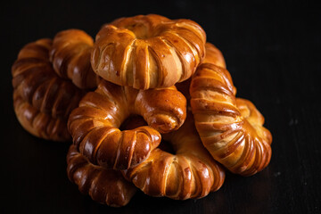 Homemade bagels close-up on a dark wooden background.