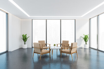 Beige armchairs in white and grey office room with plants and windows