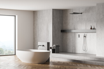 Light wooden bathroom with white bathtub near window and shower on marble floor