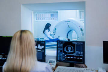 Radiologist in the control room of computed tomography at hospital