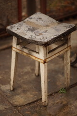 old rotten stool with screed supports in the yard