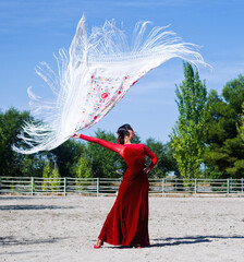 Flamenco dancer with red dress and manton de manila