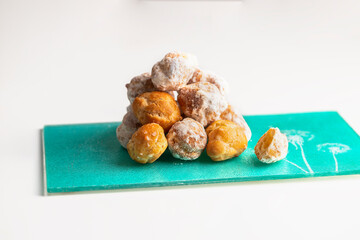 Small  deep fried doughs, Banuelos, sweets made from wheat , sugar and spices.