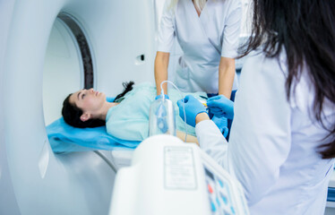 Radiologist with a female patient in the room of computed tomography