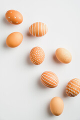 Fototapeta premium Simple Easter egg set on white background. Flat lay, top view, vertical. Minimal style.