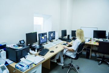 Radiologist in the control room of computed tomography at hospital