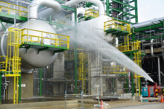 Water flowing vigorously from open fire hydrant as part of the fire extinguishing system testing for safety in the event of an emergency in chemical plants, power plants, oil and gas industry.