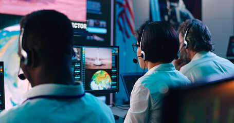 Multiracial operators working in flight control center