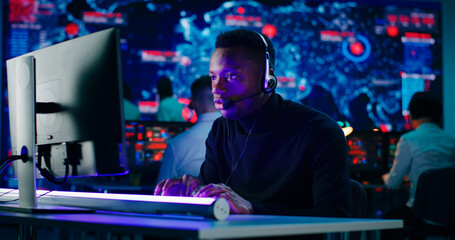 Anxious African American programmer using computer at work