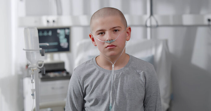 Portrait of sad suffering teen boy fighting with cancer