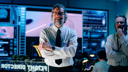 Middle aged operators watching and celebrating mission success