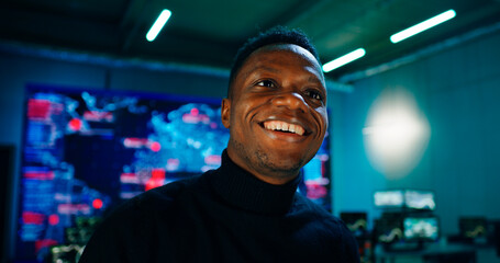 Confident black man walking in digital security office