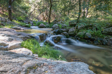 Fototapeta premium Waterfall in a sunny summer day in Cascada del Purgatorio, Madrid, Spain