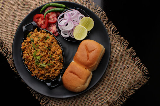 Masala Anda Bhurji or Spicy Indian scrambled eggs with bread or Bun Pav, Popular street food