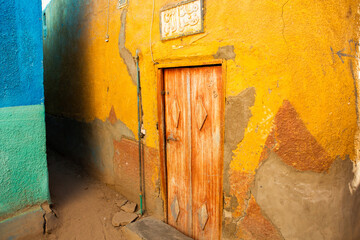 Colourful exterior wall of a Nubian house in Egypt. Typical African village houses facade. Medieval street.