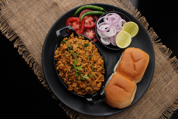 Masala Anda Bhurji or Spicy Indian scrambled eggs with bread or Bun Pav, Popular street food