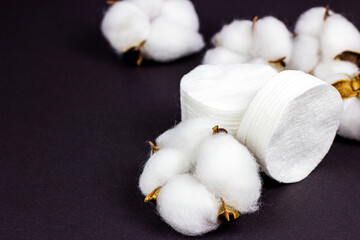 White soft cotton pads for hygiene and healthcare with copy space on black background.