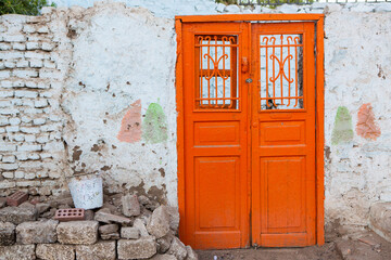 Colourful exterior wall of a Nubian house in Egypt. Typical African village houses facade. Medieval street.