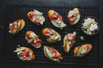 Small appetizers with prosciutto on board