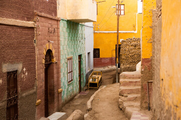 Fototapeta na wymiar Colourful exterior wall of a Nubian house in Egypt. Typical African village houses facade. Medieval street.