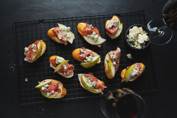 Small appetizers with prosciutto on board