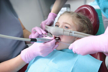 Dental treatment in a child with the use of nitrous oxide. Relaxation of the patient before surgical or dental procedures. Children's modern dentistry. The concept of healthcare. - obrazy, fototapety, plakaty