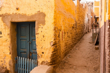 Colourful exterior wall of a Nubian house in Egypt. Typical African village houses facade. Medieval street.