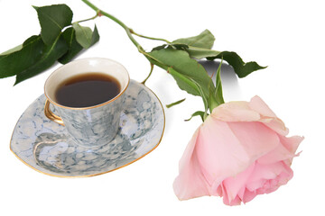 Small cup of black coffee and beautiful pink rose on white background
