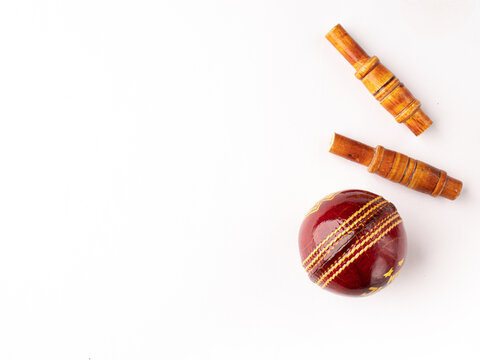 Red cricket ball and bells isolated stock image with white background.
