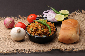 Masala Anda Bhurji or Spicy Indian scrambled eggs with bread or Bun Pav, Popular street food