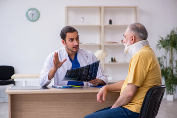 Old neck injured man visiting young male doctor radiologist