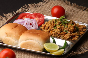 Masala Anda Bhurji or Spicy Indian scrambled eggs with bread or Bun Pav, Popular street food