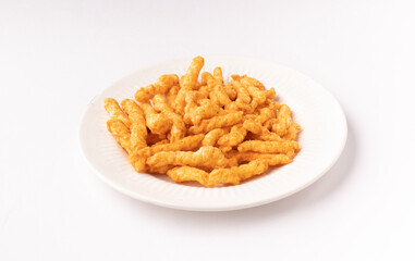 Kurkure  on plate isolated stock image with white background.