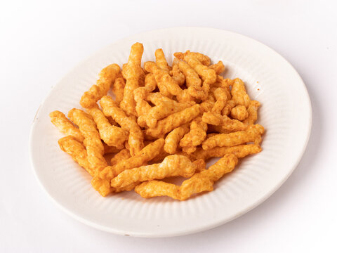 Kurkure  on plate isolated stock image with white background.