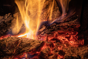 Burning billets in fireplace as abstract background