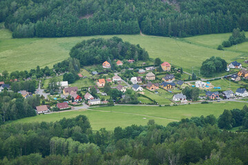 Fototapeta na wymiar Aerial view on small Czech village with green fields and forest around