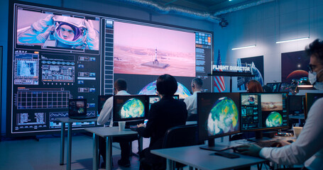 Team watching rocket launch in office © Framestock