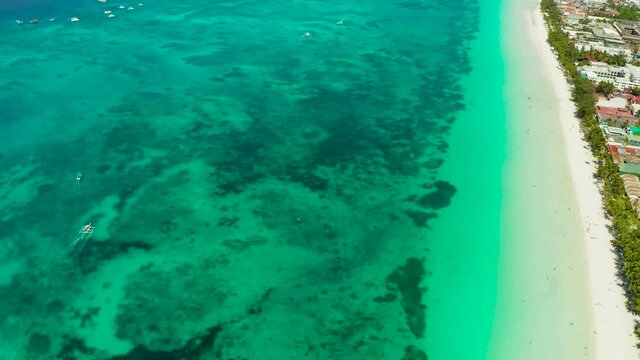 Tropical white sand beach, hotels near the blue lagoon and corall reef. aerial view, Boracay, Philippines. Seascape with beach on tropical island. Summer and travel vacation concept.