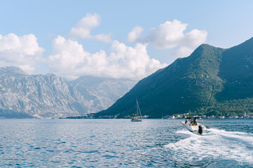 A motor boat cuts through the water in the Bay of Kotor in Montenegro. The concept of sea tourism and recreation.