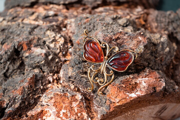 Bronze brooch in the form of a butterfly on a wooden background