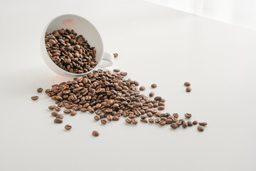 Coffee beans and cup on white background 