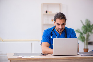 Young male doctor in telemedicine concept
