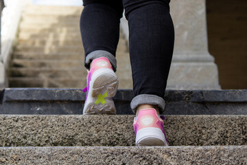 Fototapeta na wymiar close-up of sneakers walking up the stairs 