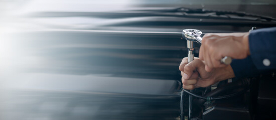 Car service, repair, maintenance concept. Auto mechanic working in garage.