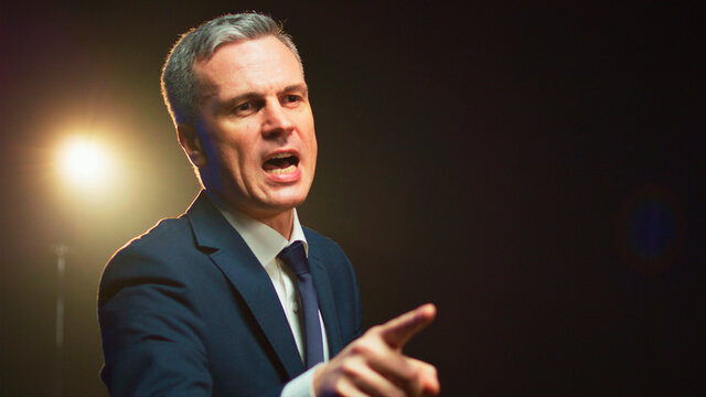 Aggressive man speaking about politics from stage