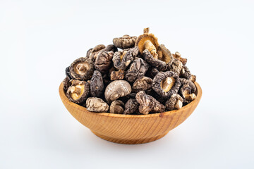 Dried small shiitake mushrooms on white background