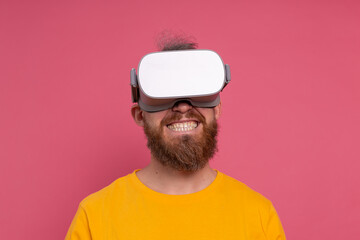 Positive fun happy man in vr glasses on studio  background