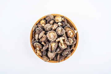 Dried small shiitake mushrooms on white background