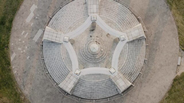 Flying above a mysterious stone altar. Memorial place, forgotten cemetery from above. Top down view of a symmetrical architecturee.